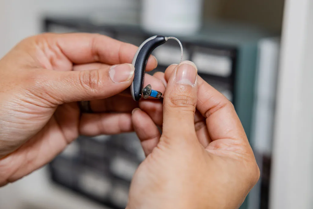 A close-up of hearing aids resting on a table.