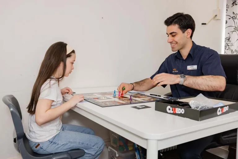 A child participating in a speech therapy session using the Cluedo board game at South Australia Speech and Hearing Centre