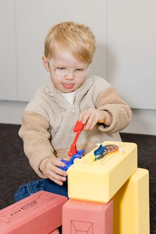 A child concentrating on a toy truck during a speech therapy session at South Australia Speech and Hearing Centre